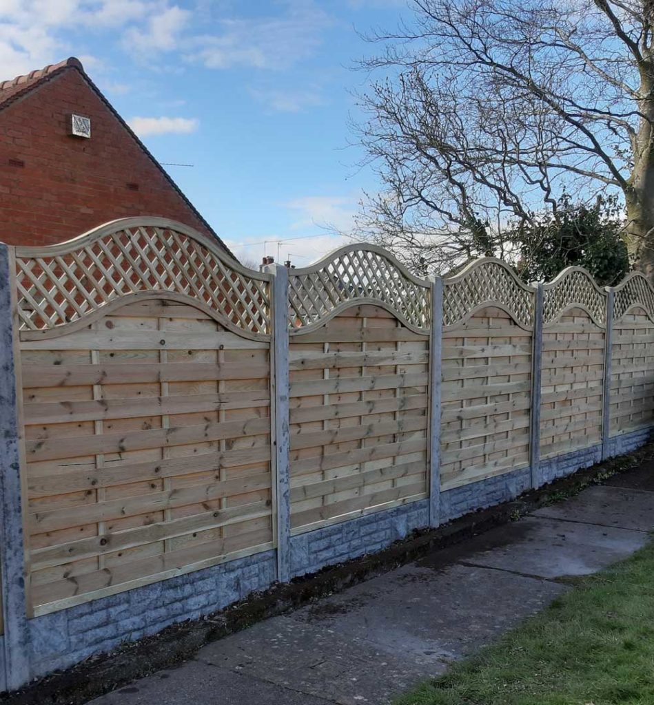 light wood fence with curved top